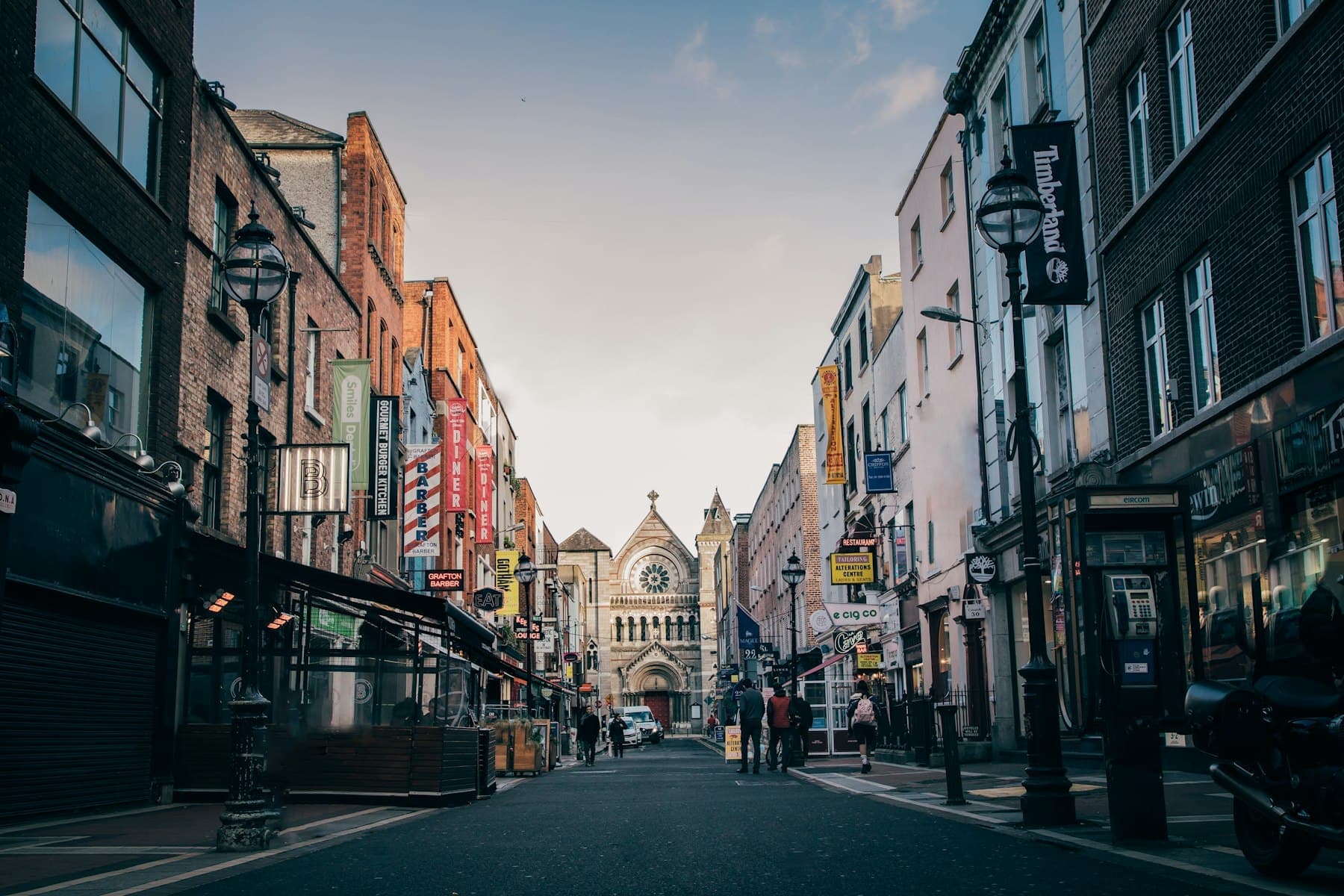 A Dublin street lined with shops leading to a church