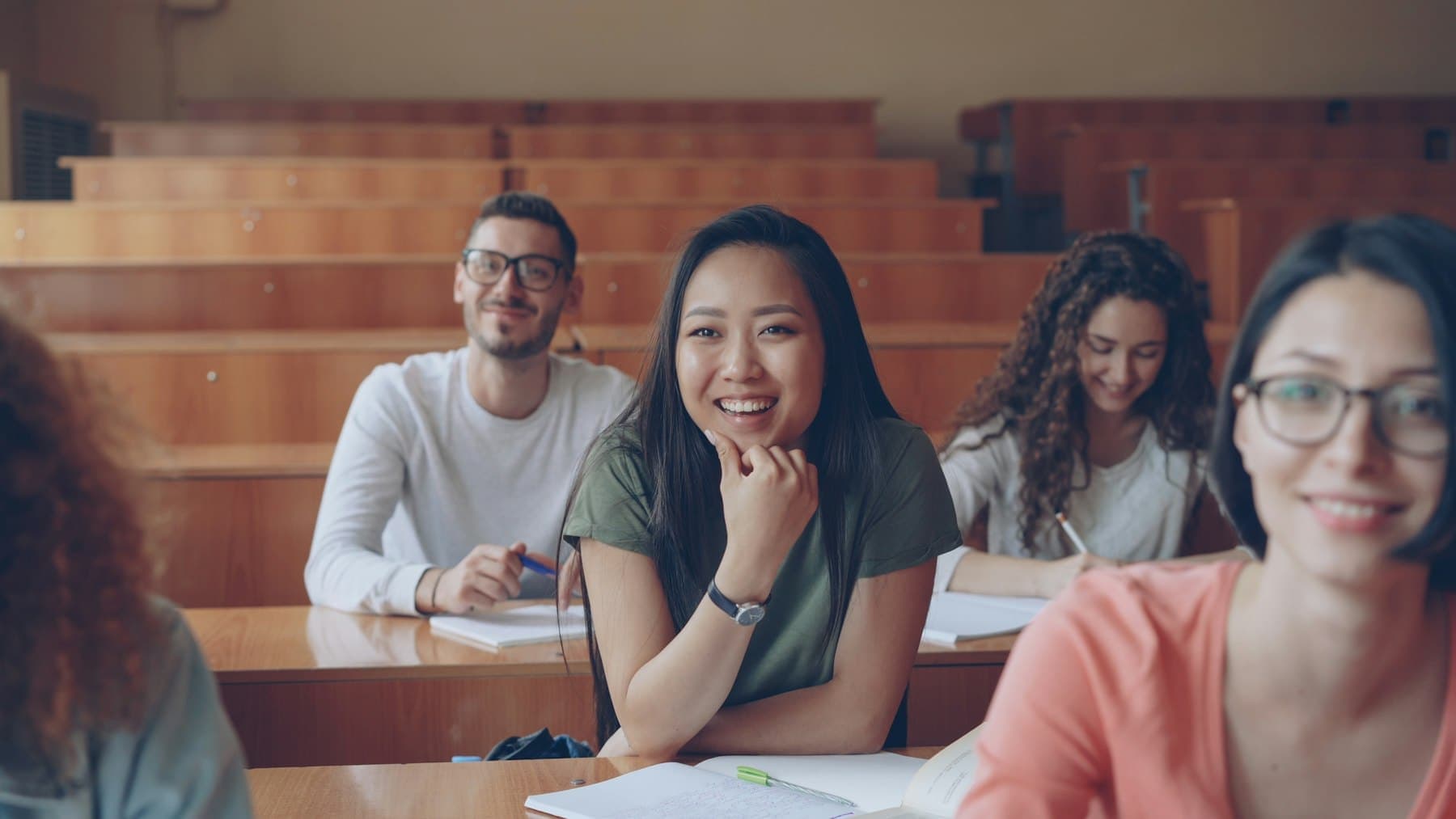 Students smiling in a lecture hall