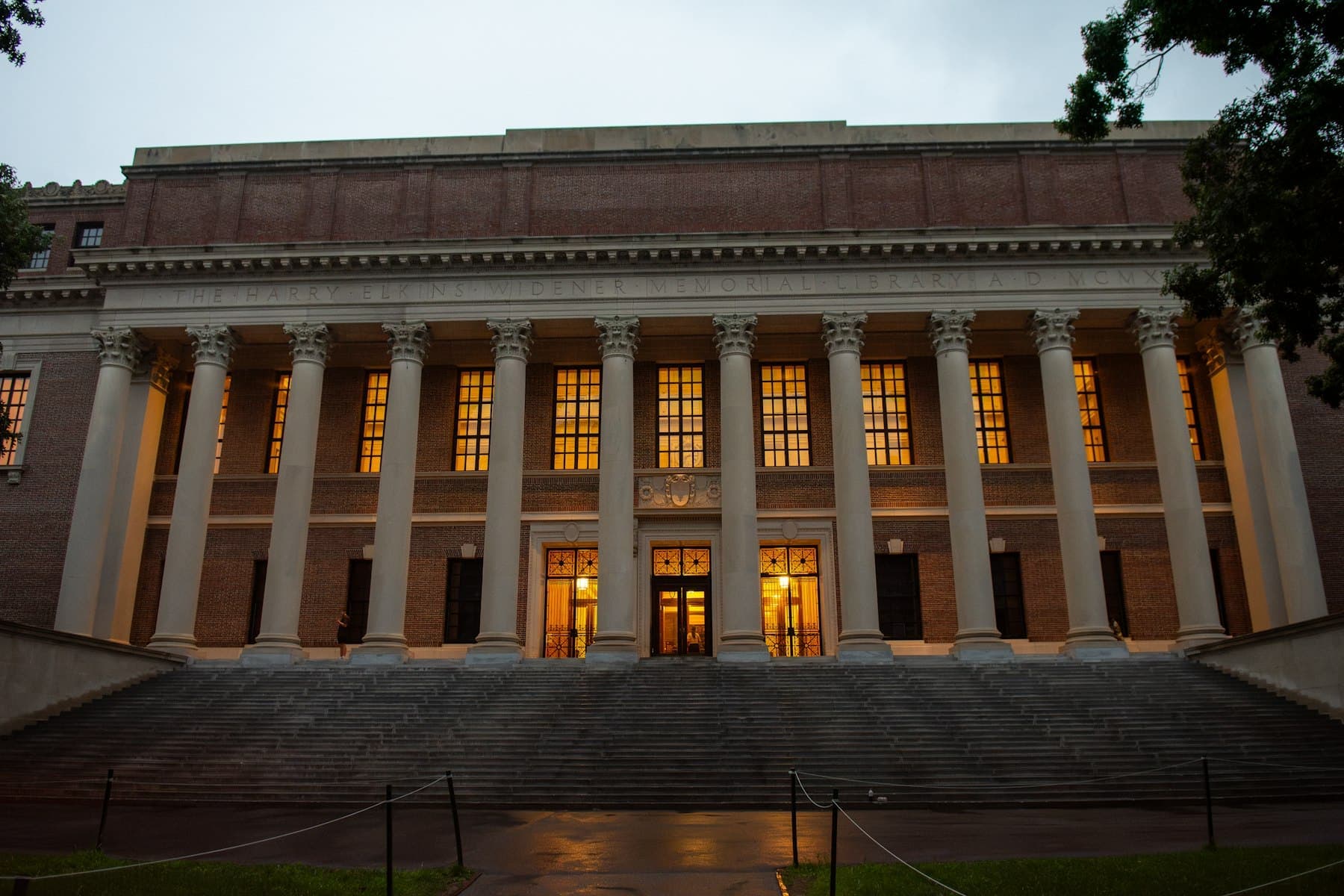 A columned university library lit at dusk